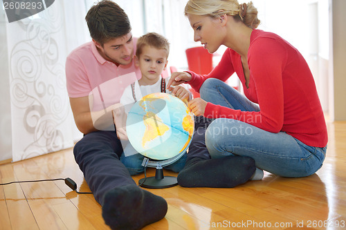 Image of family have fun with globe