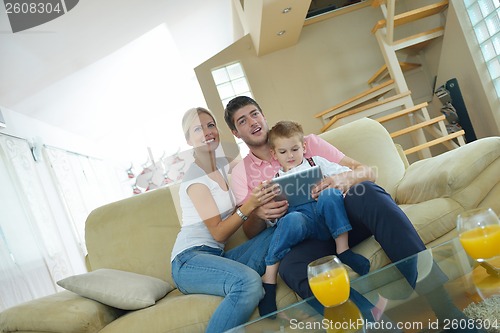Image of family at home using tablet computer