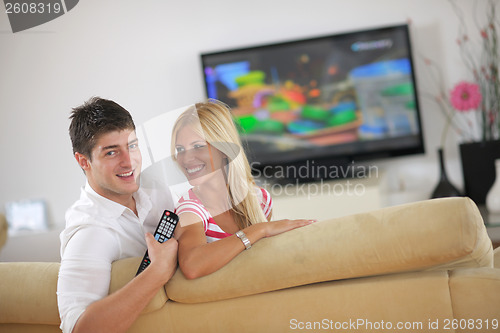 Image of Relaxed young  couple watching tv at home