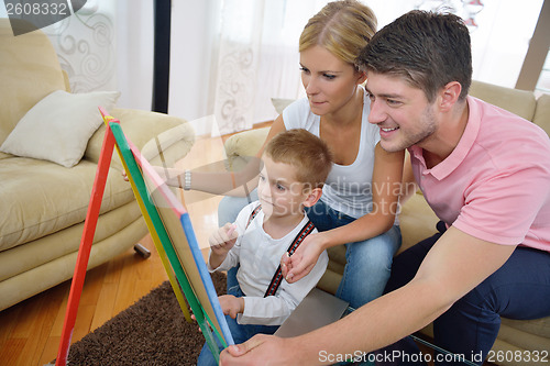 Image of family drawing on school board at home