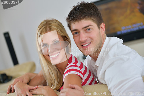 Image of Relaxed young  couple watching tv at home