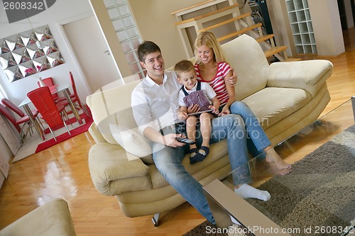 Image of family at home using tablet computer