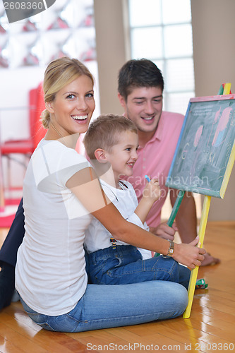 Image of family drawing on school board at home