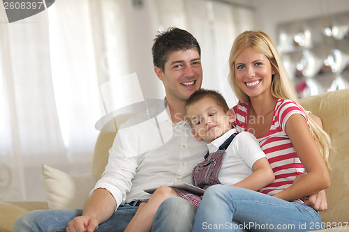 Image of family at home using tablet computer