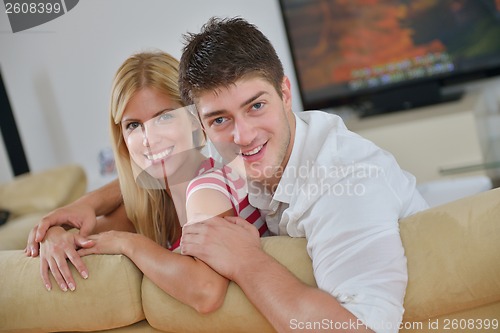 Image of Relaxed young  couple watching tv at home