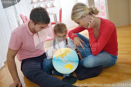 Image of family have fun with globe