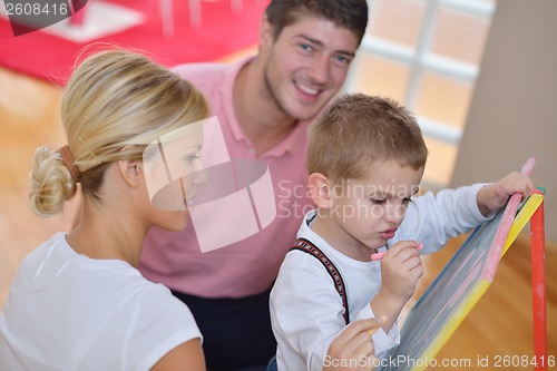 Image of family drawing on school board at home