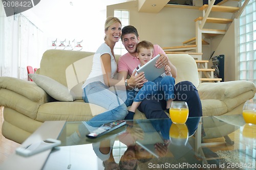 Image of family at home using tablet computer