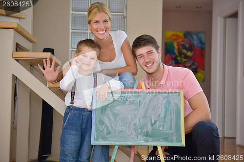 Image of family drawing on school board at home