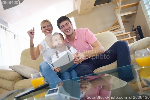 Image of family at home using tablet computer