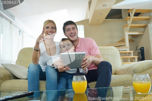 Image of family at home using tablet computer
