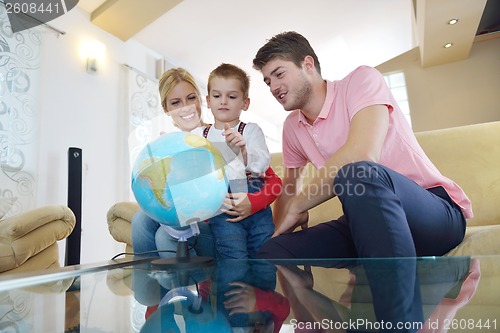 Image of family have fun with globe