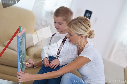 Image of family drawing on school board at home