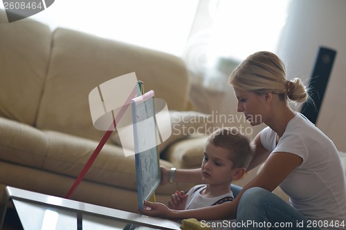 Image of family drawing on school board at home