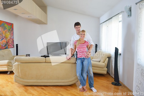 Image of Relaxed young  couple watching tv at home