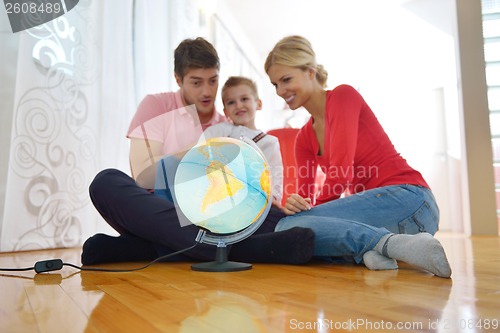 Image of family have fun with globe
