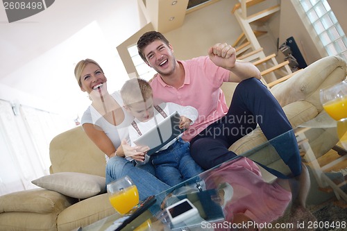 Image of family at home using tablet computer