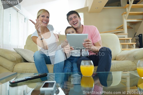 Image of family at home using tablet computer