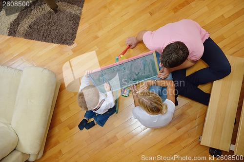 Image of family drawing on school board at home