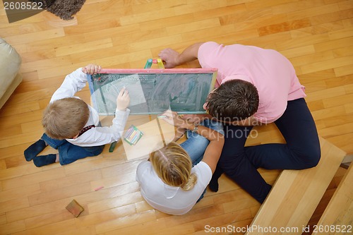 Image of family drawing on school board at home