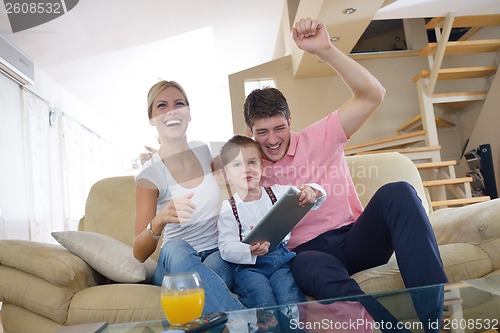 Image of family at home using tablet computer