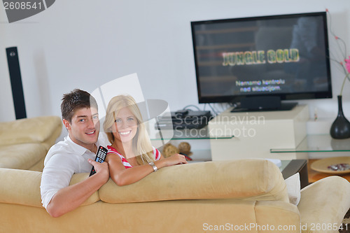 Image of Relaxed young  couple watching tv at home