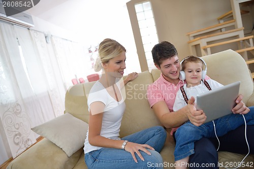 Image of family at home using tablet computer