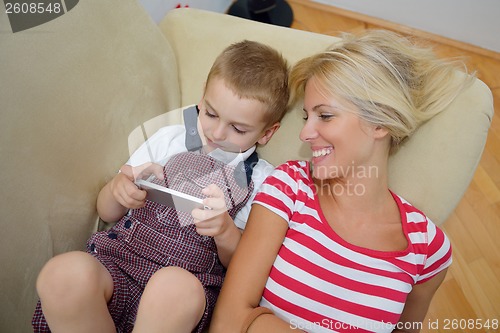 Image of family at home using tablet computer