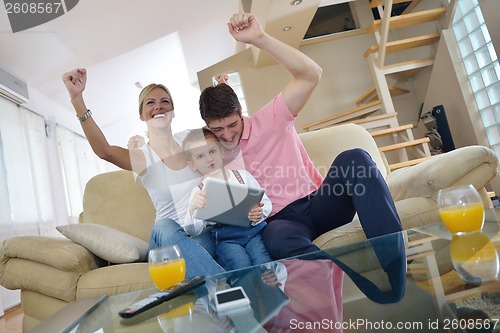 Image of family at home using tablet computer