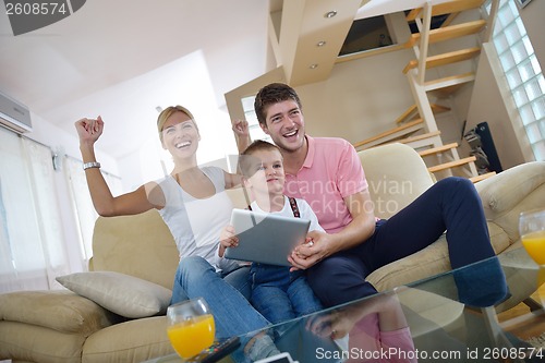 Image of family at home using tablet computer