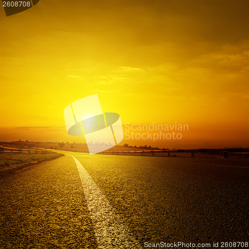 Image of asphalt road and orange sunset