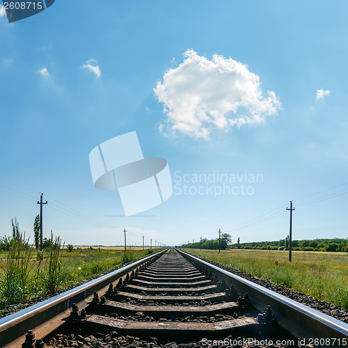 Image of cloud in blue sky over railroad