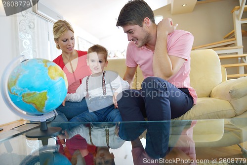 Image of family have fun with globe