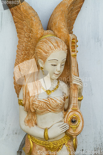 Image of Statue of girl playing an asian string instrument