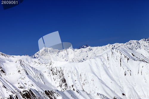 Image of Winter snowy mountains and blue sky