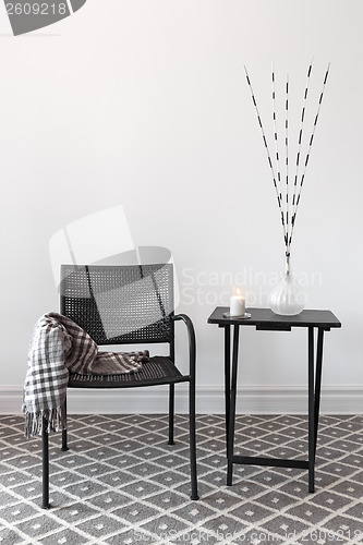 Image of Home decor. Armchair and table with decorations