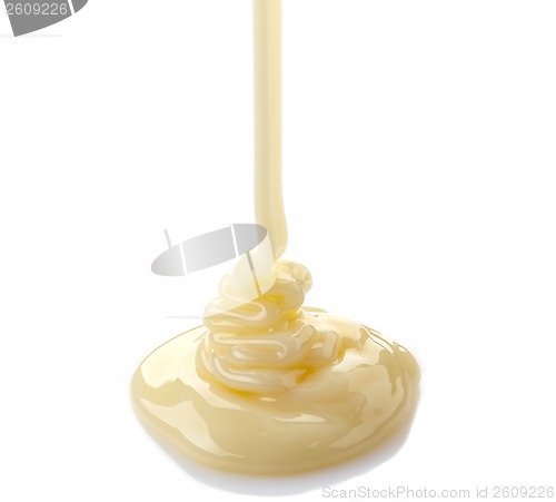 Image of pouring condensed milk on a white background