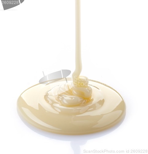 Image of pouring condensed milk on a white background