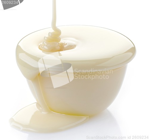 Image of pouring condensed milk with sugar in a bowl