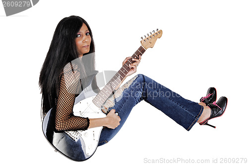 Image of Girl with guitar sitting.