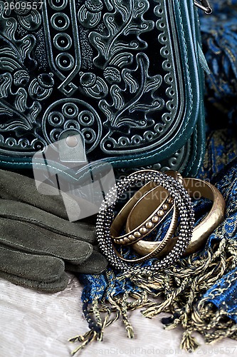 Image of vintage bag, leather gloves, bracelets and scarf 