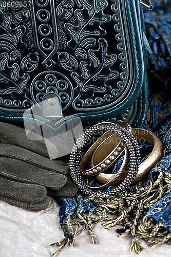 Image of vintage bag, leather gloves, bracelets and scarf 