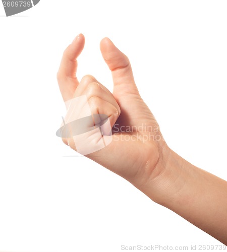 Image of Human hand holding something with two fingers