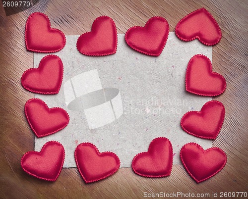 Image of red hearts on vintage  paper background