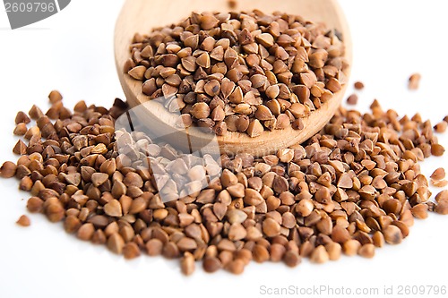 Image of Buckwheat seeds on wooden spoon in closeup 