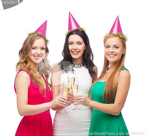 Image of three women in pink hats with champagne glasses