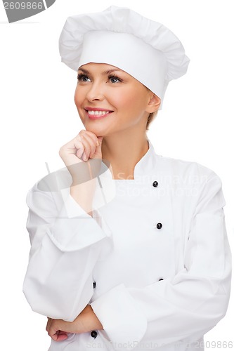 Image of smiling female chef dreaming