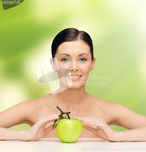 Image of beautiful woman with green apple