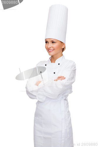 Image of smiling female chef with crossed arms