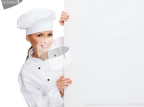 Image of smiling female chef with white blank board